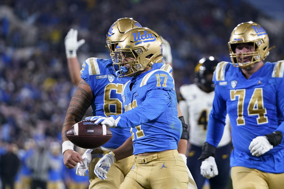 UCLA wide receiver Logan Loya, center, celebrates his touchdown next to offensive linemen Duke Clemens, left, and Spencer Holstege during the first half of an NCAA college football game against California, Saturday, Nov. 25, 2023, in Pasadena, Calif. (AP Photo/Ryan Sun)