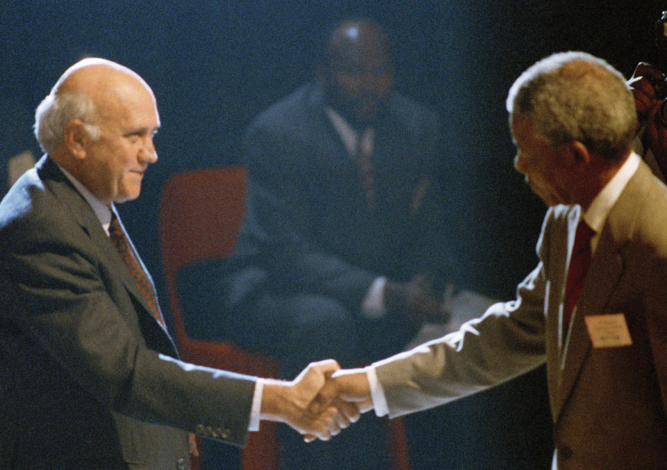 FILE — In this Dec. 21, 1991 file photo taken by South African photographer, John Parkin, South African State President F W de Klerk, shakes hands with African National Congress President Nelson Mandela, right, at the end of the talks between the Government and anti-apartheid groups to end white-minority rule in Johannesburg, South Africa, at the World Trade Center. Parkin, who covered the country's anti-apartheid struggle, its first democratic elections, and the presidency of Nelson Mandela, has died Monday Aug. 23, 2021, at the age of 63 according to his daughter. (AP Photo/ John Parkin/File)