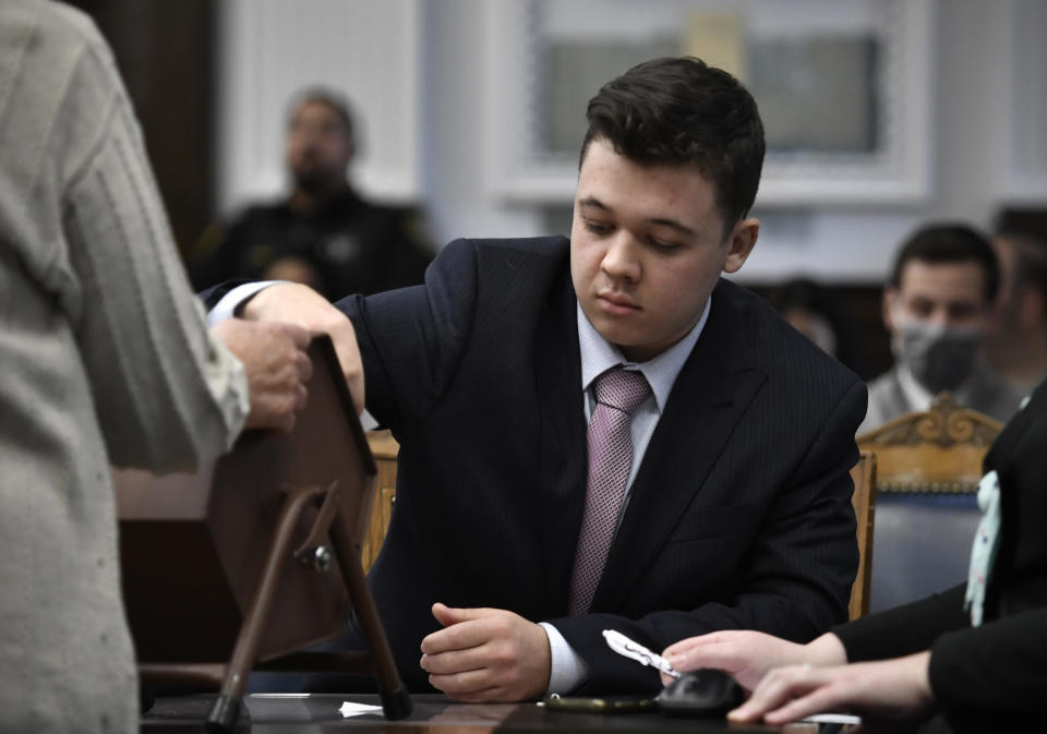 Kyle Rittenhouse pulls numbers of jurors out of a tumbler during his trail at the Kenosha County Courthouse in Kenosha, Wisconsin on November 16, 2021.  / Credit: SEAN KRAJACIC/AP