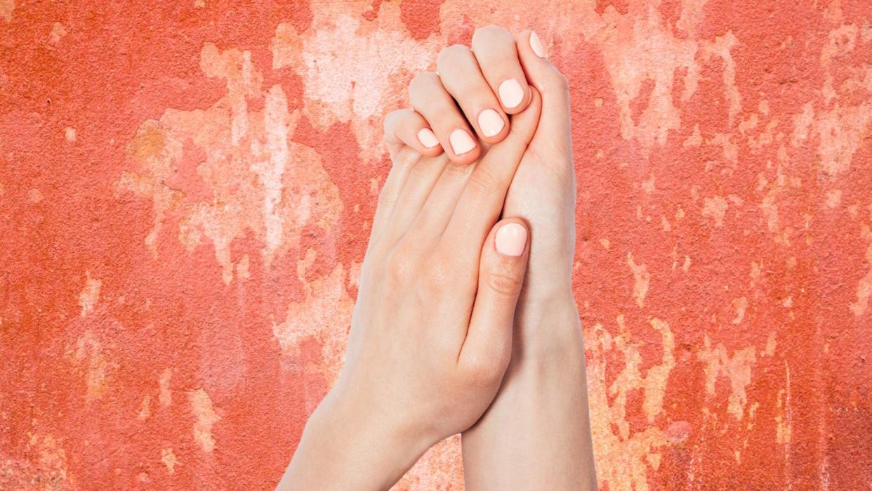 Close_Up_of_Woman’s_Hands_On_Rough_Pink_Background