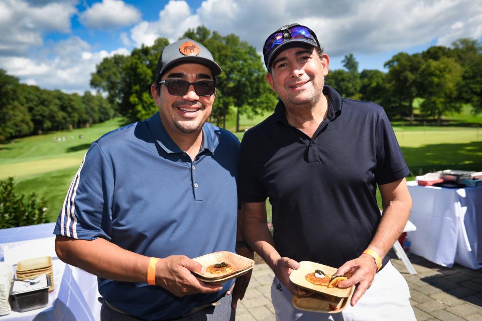 Jose Garces and Arthur Backal pose for photos during the City Harvest charity event at Alpine Country Club in Demarest, Tuesday on 09/20/22. 