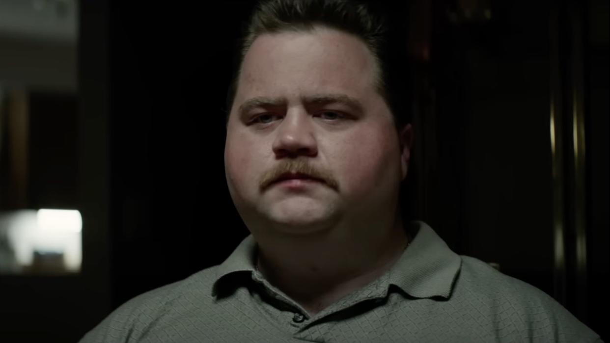  Paul Walter Hauser with mustache and wearing collared shirt in Richard Jewell. 