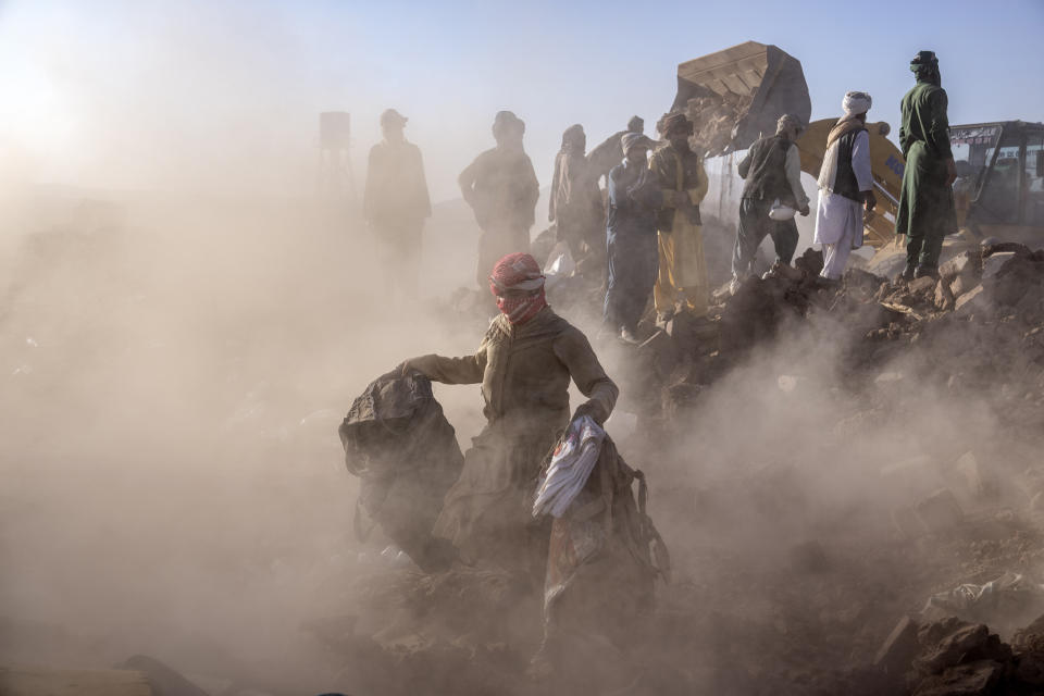 Afghan men search for victims after an earthquake in Zenda Jan district in Herat province, of western Afghanistan, Monday, Oct. 9, 2023. Saturday's deadly earthquake killed and injured thousands when it leveled an untold number of homes in Herat province. (AP Photo/Ebrahim Noroozi)