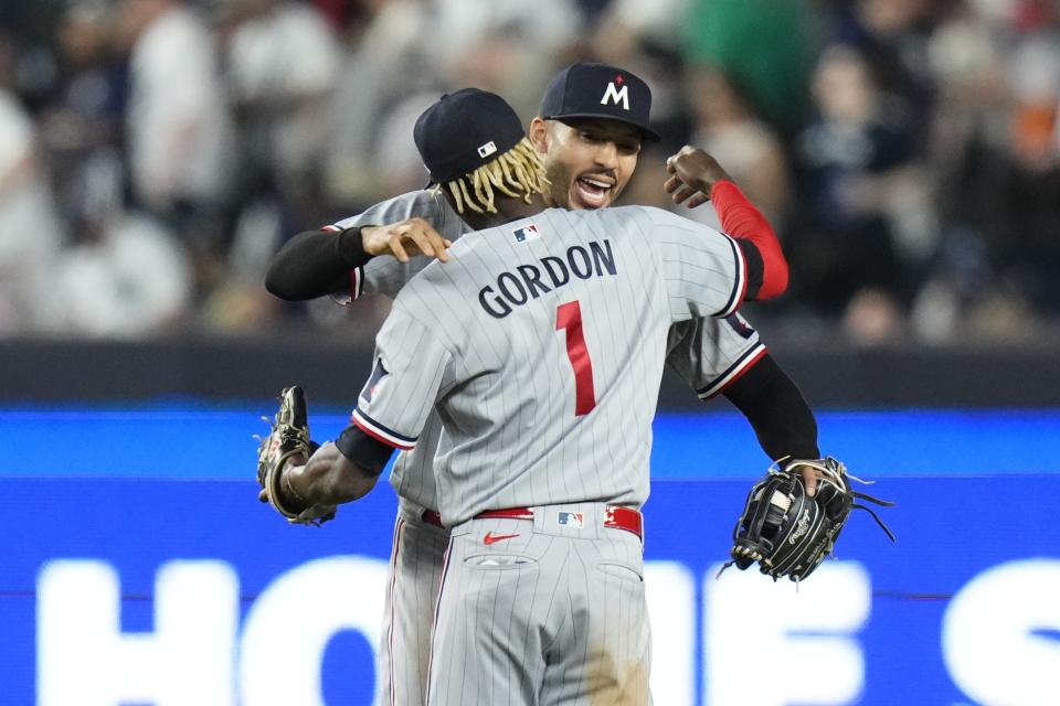 Minnesota Twins' Carlos Correa, rear, celebrates with Nick Gordon after the team's baseball game against the New York Yankees on Friday, April 14, 2023, in New York. The Twins won 4-3. (AP Photo/Frank Franklin II)
