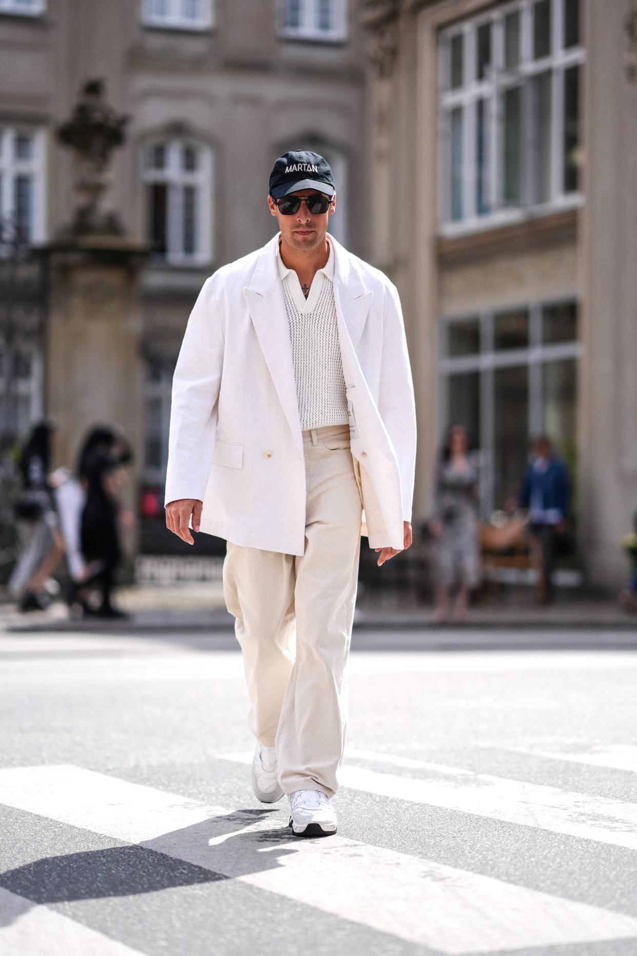 A man walks outside Copenhagen Fashion Week while wearing a "smart casual" outfit.