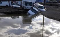 Flood-destroyed trucks are reflected in flood waters in Longmont, Colorado September 16, 2013. (REUTERS/Rick Wilking)