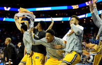 <p>The UMBC Retrievers bench celebrates a growing second half lead against the Virginia Cavaliers during the first round of the 2018 NCAA Men’s Basketball Tournament at Spectrum Center on March 16, 2018 in Charlotte, North Carolina. (Photo by Jared C. Tilton/Getty Images) </p>