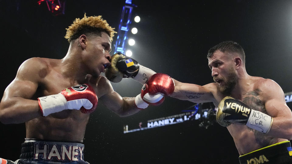 Devin Haney, left, fights Vasiliy Lomachenko in an undisputed lightweight championship boxing match Saturday, May 20, 2023, in Las Vegas. Haney won by unanimous decision. (AP Photo/John Locher)