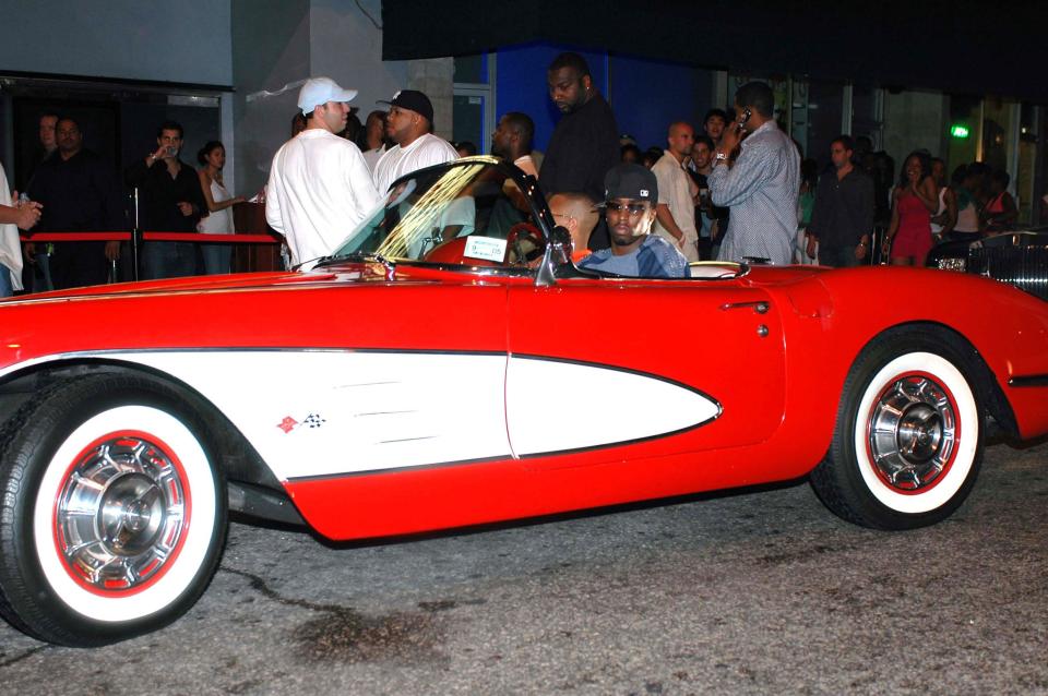 Sean Combs driving a 1956 Corvette convertable