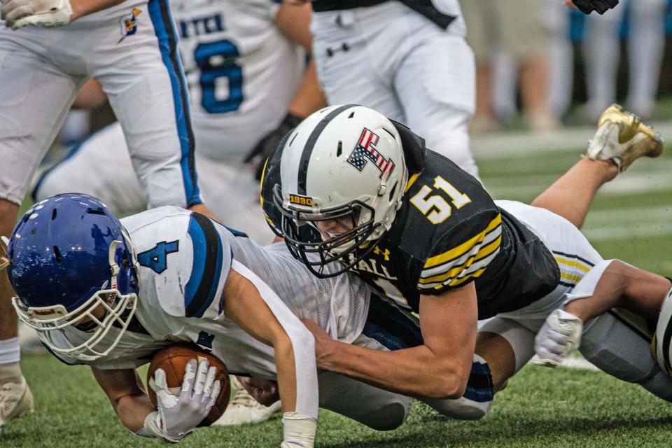 Tatnall junior Jack Homer (51) takes down Charter of Wilmington senior John Foley (4) during the DIAA Class 1A football championship at Delaware Stadium in Newark, Saturday, Dec. 2, 2023. Tatnall won 26-7.