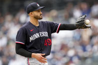 Minnesota Twins starting pitcher Pablo Lopez (49) receives the ball in the first inning of a baseball game against the New York Yankees, Sunday, April 16, 2023, in New York. (AP Photo/John Minchillo)