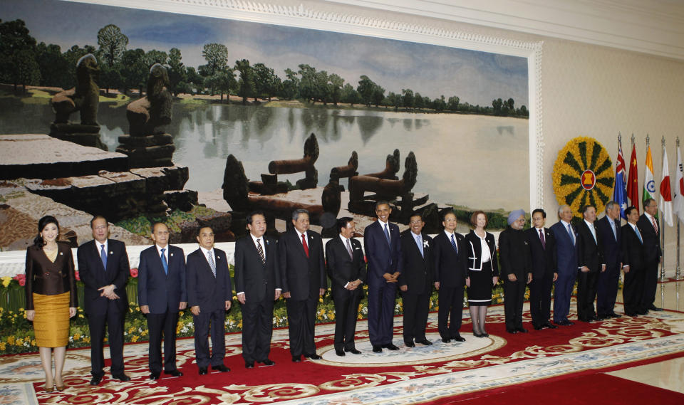 U.S. President Barack Obama, eighth from left, smiles as he stands with other leaders for a group photo at the East Asia Summit in Phnom Penh, Cambodia, Tuesday, Nov. 20, 2012. They are, from left, Thailand's Prime Minister Yingluck Shinawatra, Philippines' President Benigno Aquino III, Myanmar's President Thein Sein, Laos' Prime Minister Thongsing Thammavong, Japan's Prime Minister Yoshihino Noda, Indonesia's President Susilo Bambang Yudhoyono, Brunei's Sultan Hassanal Bolkiah, Obama, Cambodia's Prime Minister Hun Sen, China's Premier Wen Jiabao, Australia's Prime Minister Julia Gillard, India's Prime Minister Manmohan Singh, South Korea's President Lee Myung-bak, Malaysia's Prime Minister Najib Razak, New Zealand's Prime Minister John Key, Singapore's Prime Minister Lee Hsien Loong, Vietnam's Prime Minister Nguyen Tan Dung and Russia's Foreign Minister Sergei Lavrov. (AP Photo/Vincent Thian)