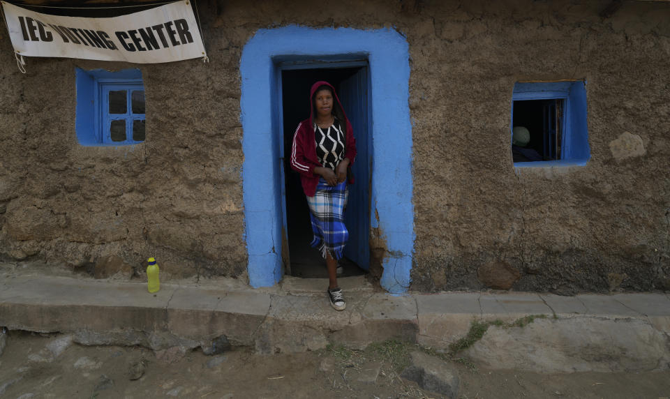 A woman walks out of a polling station after casting her vote in Thaba-Tseka District, 82km east of Maseru, Lesotho, Friday, Oct. 7, 2022. Voters across Lesotho are heading to the polls Friday to elect a leader to find solutions to high unemployment and crime. (AP Photo/Themba Hadebe)