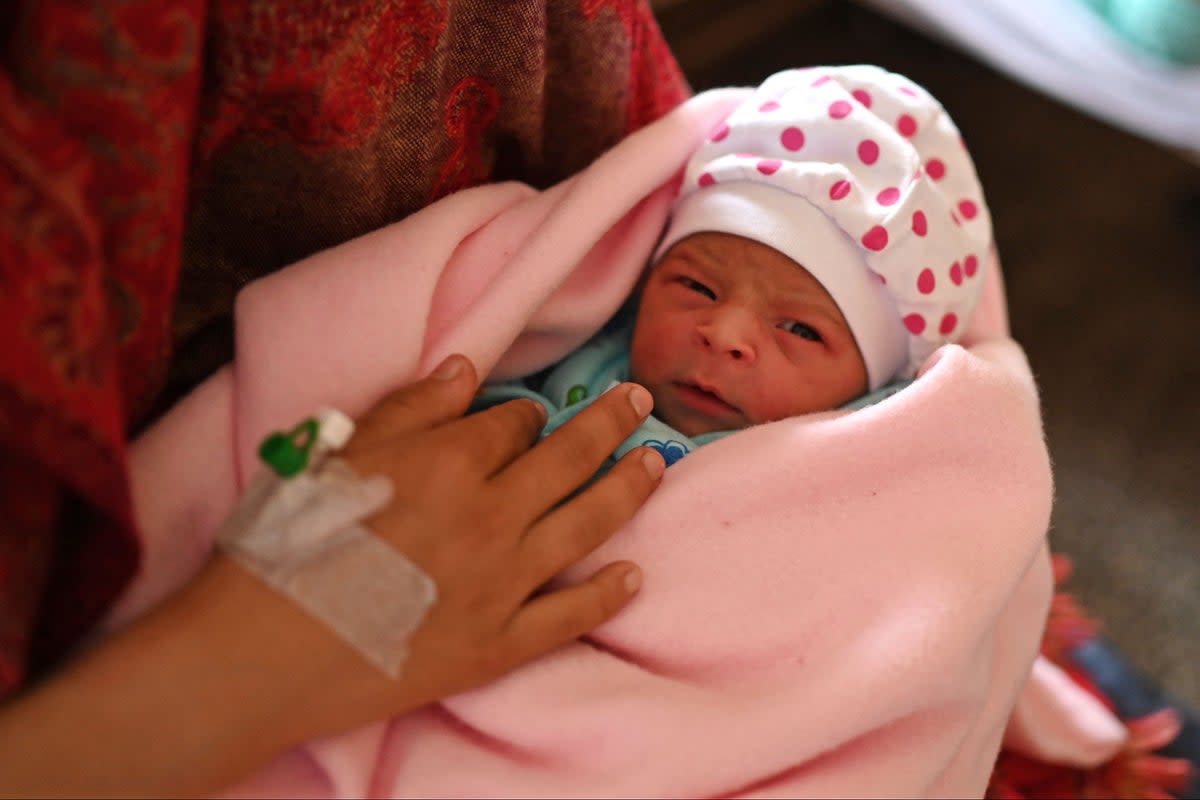 Manu Bala holding her newborn daughter ion Tuesday.  (AFP/ Getty)