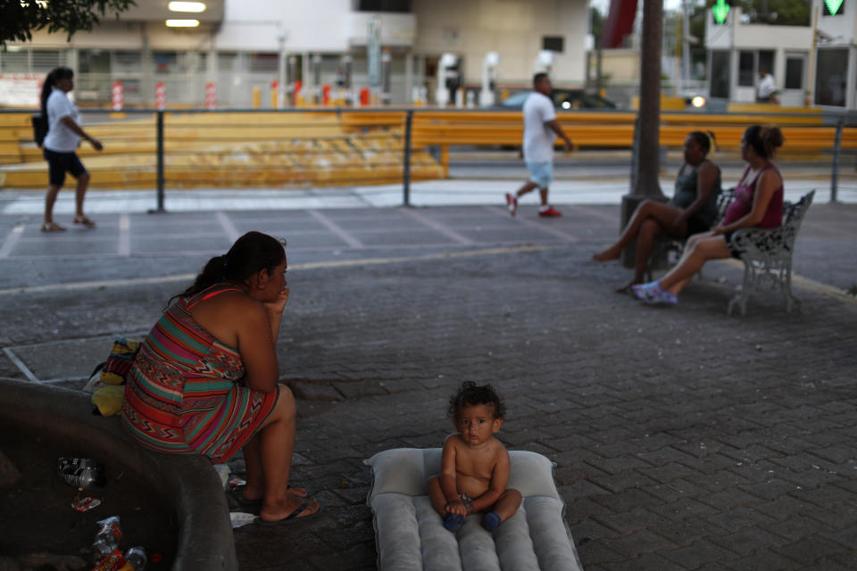 A Honduran boy, who is waiting with his family to request asylum, rests on an air mattress at the entrance to the Puerta Mexico international bridge in Matamoros, Tamaulipas state, Mexico, Friday, June 28, 2019. Hundreds of migrants from Central America, South America, the Caribbean and Africa have been waiting, most in rented rooms or a distant shelter, for their number to be called at the bridge in downtown Matamoros, to have the opportunity to request asylum in the U.S.(AP Photo/Rebecca Blackwell)