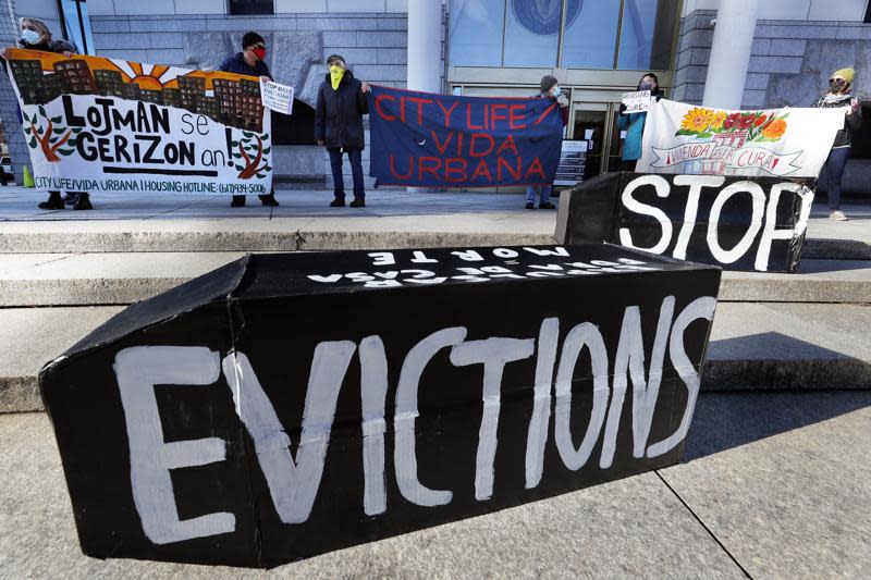 In this Jan. 13, 2021, file photo, tenants’ rights advocates demonstrate in front of the Edward W. Brooke Courthouse in Boston. (AP Photo/Michael Dwyer, File)