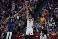 Miami Heat guard Max Strus (31) shoots over Denver Nuggets forward Bruce Brown, left, during the first half of Game 2 of basketball's NBA Finals, Sunday, June 4, 2023, in Denver. (AP Photo/Mark J. Terrill)