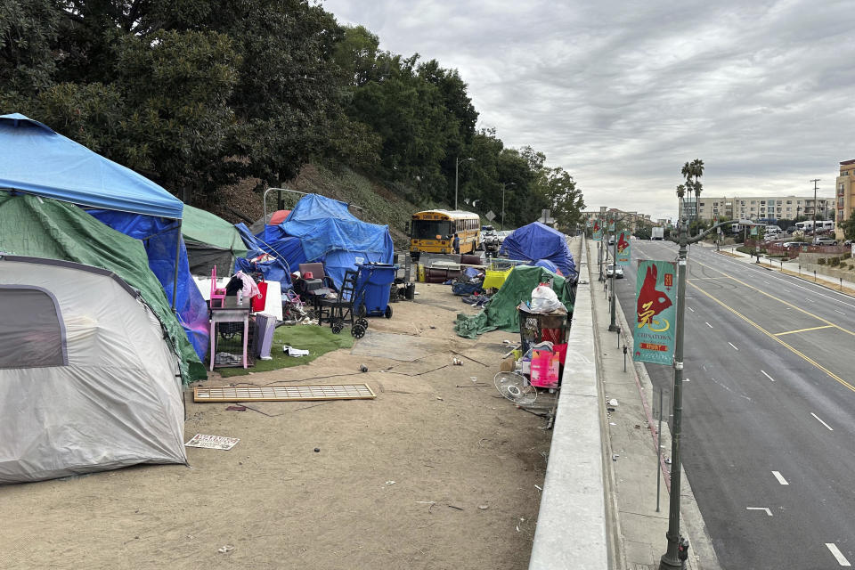 Tents line an overpass on North Hill Street above Cesar Chavez Avenue near U.S. 101 in Los Angeles, Wednesday, Nov. 15, 2023. (AP Photos/Christopher Weber)