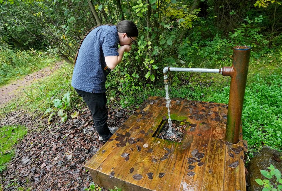 Bazile Minogiizhigaabo Panek, a member of the Red Cliff Band for Lake Superior Ojibwe and consultant for the Institute for Tribal Environmental Professionals based in Arizona, takes a drink water from an artesian well at Prentice Park, just south of Lake Superior in Ashland.