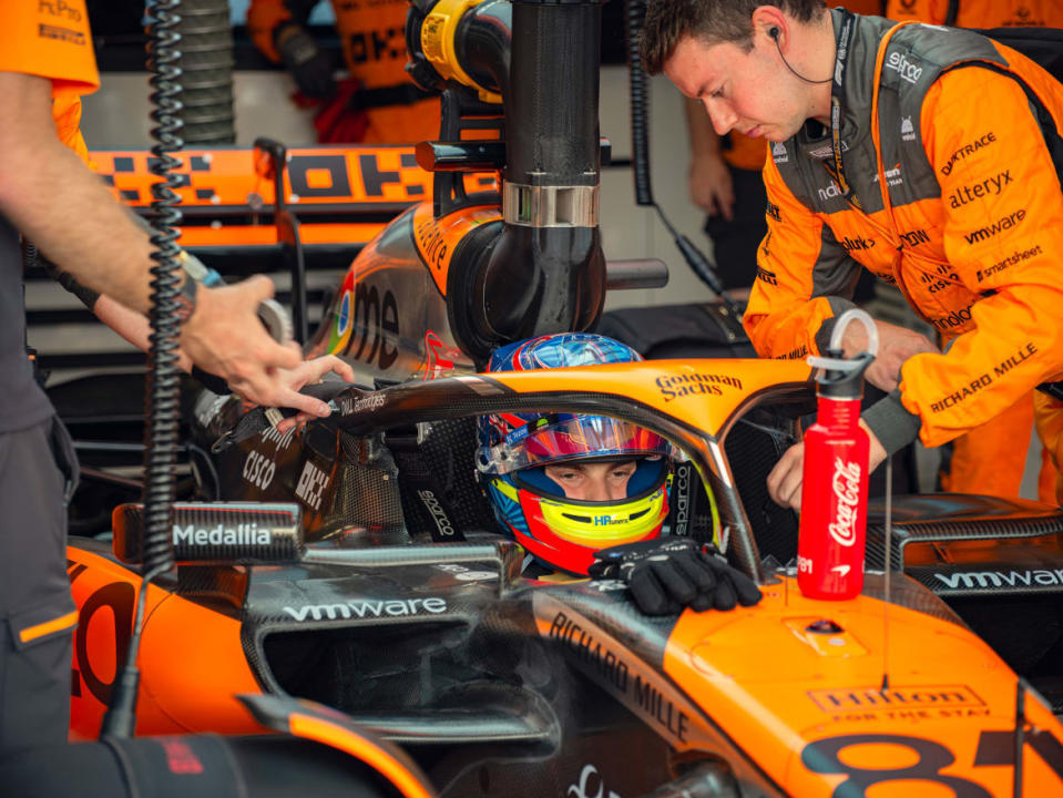 Oscar Piastri sits in his car as his crew works on it in a still from Formula 1: Drive to Survive