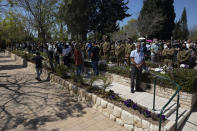 Israelis soldiers and families stand during a ceremony marking the annual Memorial Day for fallen soldiers, at the Kiryat Shaul Military Cemetery in Tel Aviv, Israel, Wednesday, April 14, 2021. Memorial Day is the most solemn day on Israel's national calendar. (AP Photo/Sebastian Scheiner)