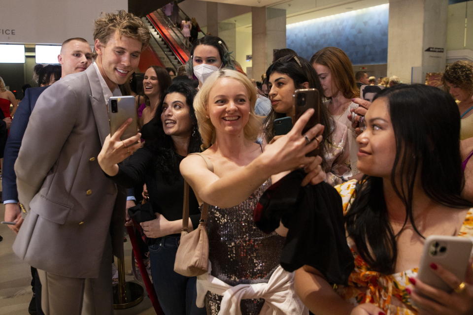 Actor Austin Butler greets fans as he arrives for a screening of the film, "Elvis," in Toronto, Friday, June 17, 2022. (Chris Young/The Canadian Press via AP)