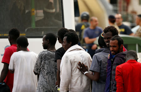 Migrants line up to get on a police bus after they disembarked from an Armed Forces of Malta patrol boat at its base in Marsamxett Harbour, Valletta, Malta May 25, 2019. REUTERS/Darrin Zammit Lupi