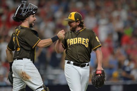 Aug 10, 2018; San Diego, CA, USA; San Diego Padres catcher Austin Hedges (left) and relief pitcher Kirby Yates (39) celebrate a 2-0 win over the Philadelphia Phillies at Petco Park. Mandatory Credit: Jake Roth-USA TODAY Sports