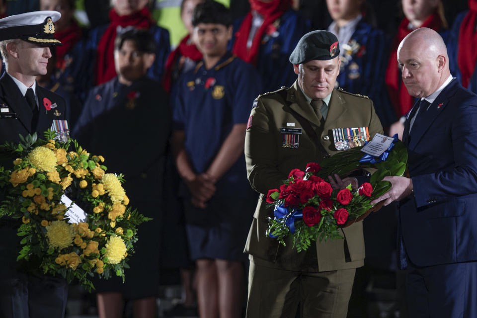 New Zealand Prime Minister Christopher Luxon, right, lays a wreath at the Anzac Day dawn service at the Auckland War Memorial Museum in Auckland, New Zealand, Thursday, April 25, 2024. (Hayden Woodward /NZ Herald via AP)