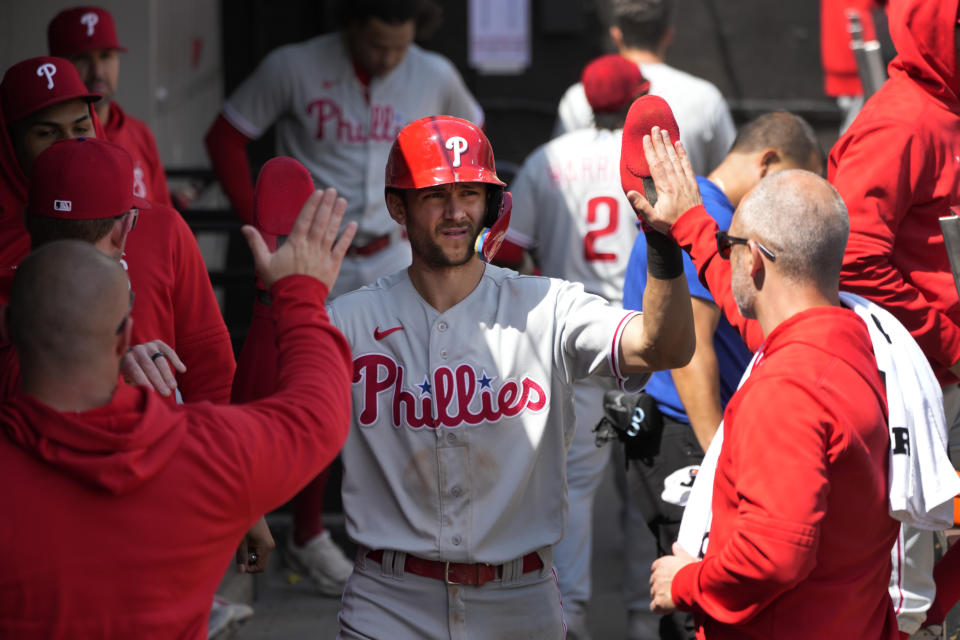 Philadelphia Phillies' Trea Turner celebrates in the dugout after scoring on a single by Nick Castellanos during the third inning of a baseball game against the Chicago White Sox, Wednesday, April 19, 2023, in Chicago. (AP Photo/Charles Rex Arbogast)