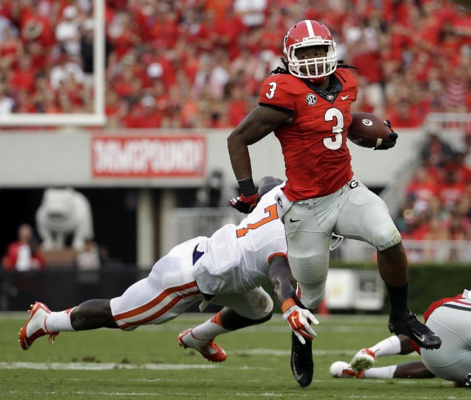 Georgia&#39;s Todd Gurley, right, runs past the reach of Clemson&#39;s Tony Steward in the first half of an NCAA college football game, Saturday, Aug. 30, 2014, in Athens, Ga. Georgia won 45-21. (AP Photo/David Goldman)