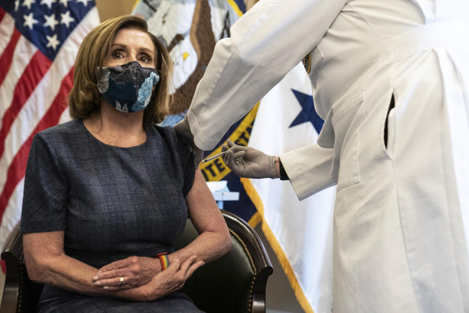Speaker of the House Nancy Pelosi, D-Calif., receives a Pfizer-BioNTech COVID-19 vaccine shot by Dr. Brian Monahan, attending physician Congress of the United States in Washington, Friday, Dec. 18, 2020. (Anna Moneymaker/The New York Times via AP, Pool)