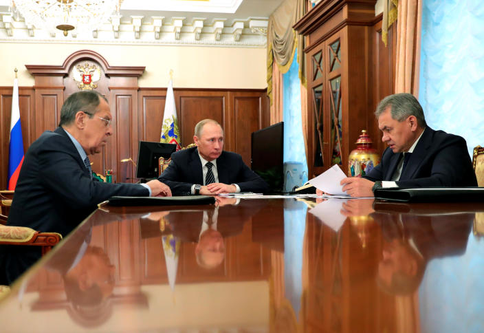 Russia's President Vladimir Putin (C), Foreign Minister Sergei Lavrov (L), and Defence Minister Sergei Shoigu attend a meeting at the Kremlin in Moscow, Russia December 29, 2016. Sputnik/Mikhail Klimentyev/Kremlin/via REUTERS ATTENTION EDITORS - THIS IMAGE WAS PROVIDED BY A THIRD PARTY. EDITORIAL USE ONLY.