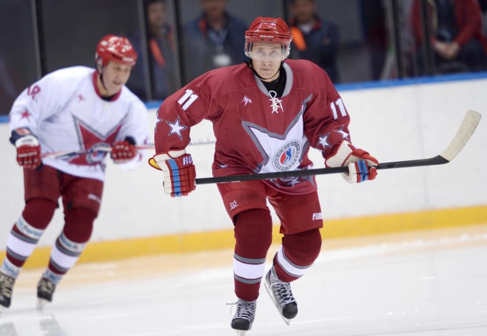 Russian President Vladimir Putin, right, takes part in a friendly hockey match between the Stars of the NHL 1 and the Stars of the NHL 2 teams at The Bolshoy Ice Dome, the part of the complex of facilities operated by the International Ice Hockey Federation (IIHF) at the Black Sea resort of Sochi, southern Russia, Saturday, Jan. 4, 2014. (AP Photo/RIA-Novosti, Alexei Nikolsky, Presidential Press Service)