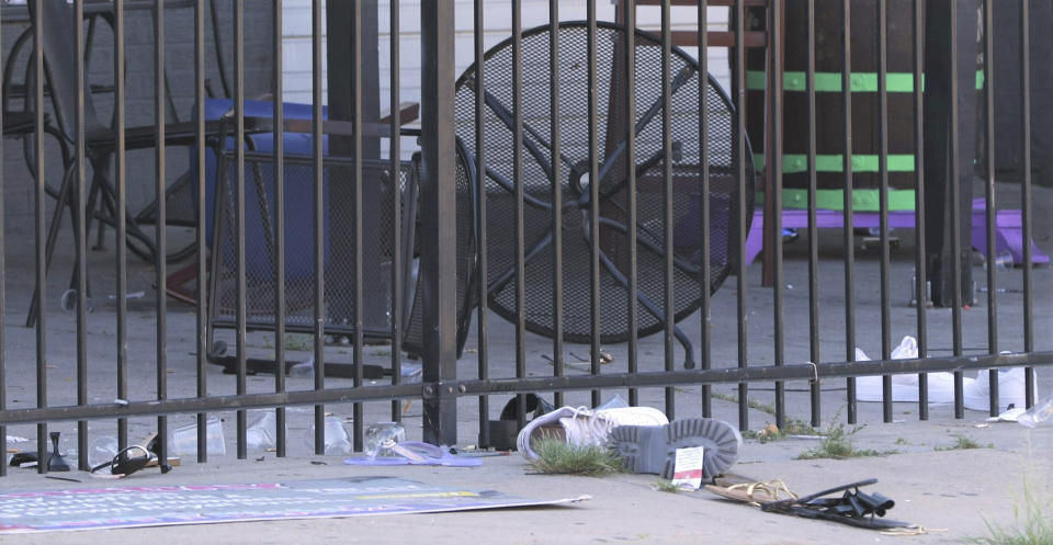 A shooting early Sunday morning, July 2, 2023, at City Nightz nightclub at 222 N. Washington in Old Town, in Wichita, Kans., left multiple people with gunshot wounds and a few more people hospitalized after being trampled in a rush for the exits, police said. Shoes, sandals, cups and overthrown chairs dotted the patio of City Nightz as crime scene investigators worked the area. (Eduardo Castillo/The Wichita Eagle via AP)