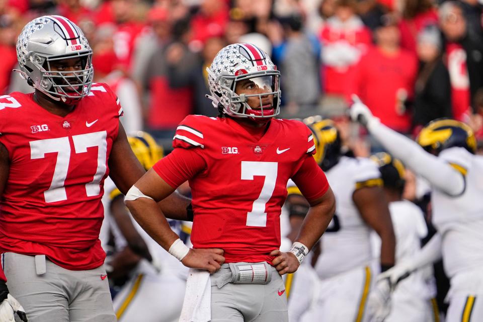 Nov 26, 2022; Columbus, Ohio, USA;  Ohio State Buckeyes offensive lineman Paris Johnson Jr. (77) hugs quarterback C.J. Stroud (7) following an interception late in the second half of the NCAA football game at Ohio Stadium. Ohio State lost 45-23. Mandatory Credit: Adam Cairns-The Columbus Dispatch