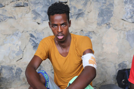 An injured Somali refugee, who was among survivors of an attack on a boat off Yemen's coast in the Red Sea, sits at a detention center in the Houthi-held port of Hodeidah, Yemen, March 22, 2017. Picture taken March 22. REUTERS/Abduljabbar Zeyad