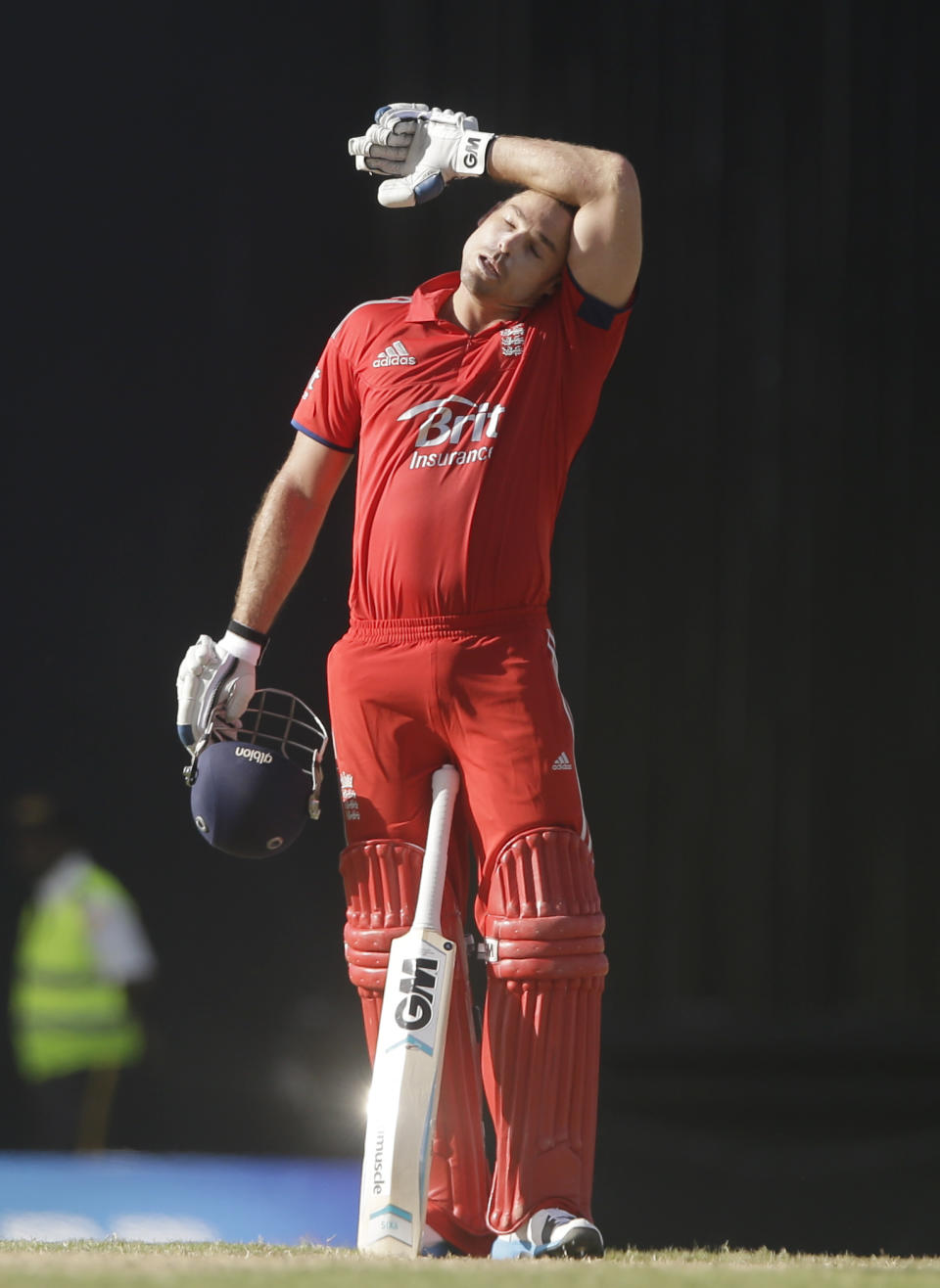 England's Michael Lumb wipes his head after he scored a century with Joe Root during their first one-day international cricket match against West Indies at the Sir Vivian Richards Cricket Ground in St. John's, Antigua, Friday, Feb. 28, 2014. (AP Photo/Ricardo Mazalan)