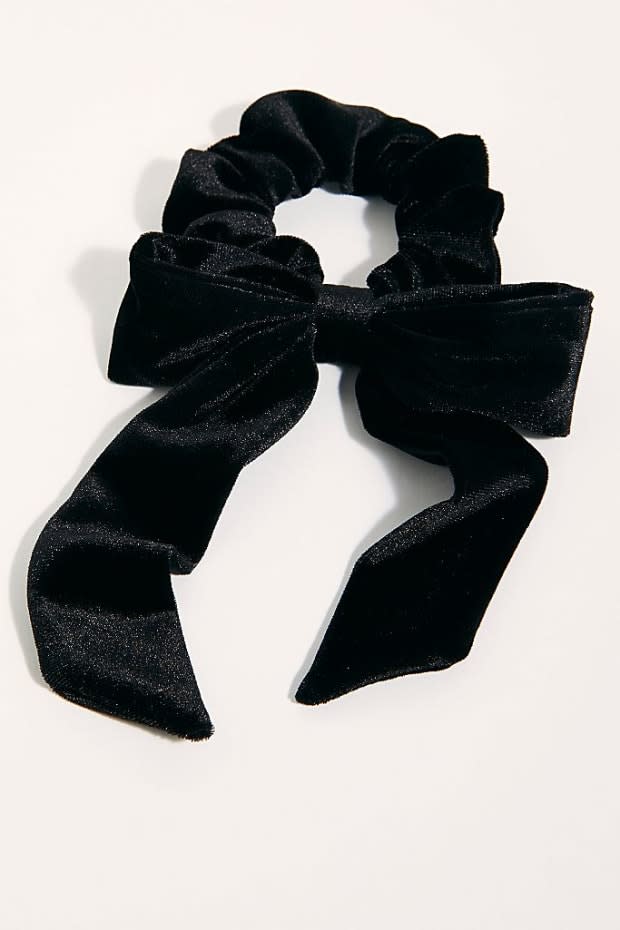 <p>Free People Velvet Bow Scrunchie, $8, <a href="https://shop-links.co/1721075974942959634" rel="nofollow noopener" target="_blank" data-ylk="slk:available here;elm:context_link;itc:0;sec:content-canvas" class="link ">available here</a>.</p>