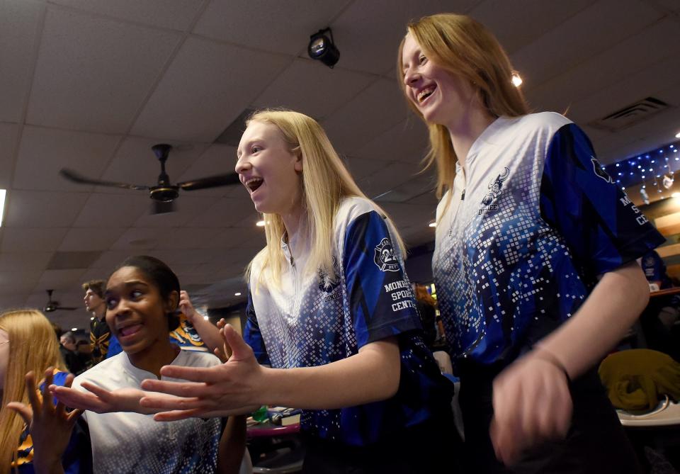 Kaylee Hovey, Abigail DeBruyne and Kiernan Brown of Dundee react after a strike thrown by a teammate on Monday, Feb. 12, 2024 at Monroe Sport Center.