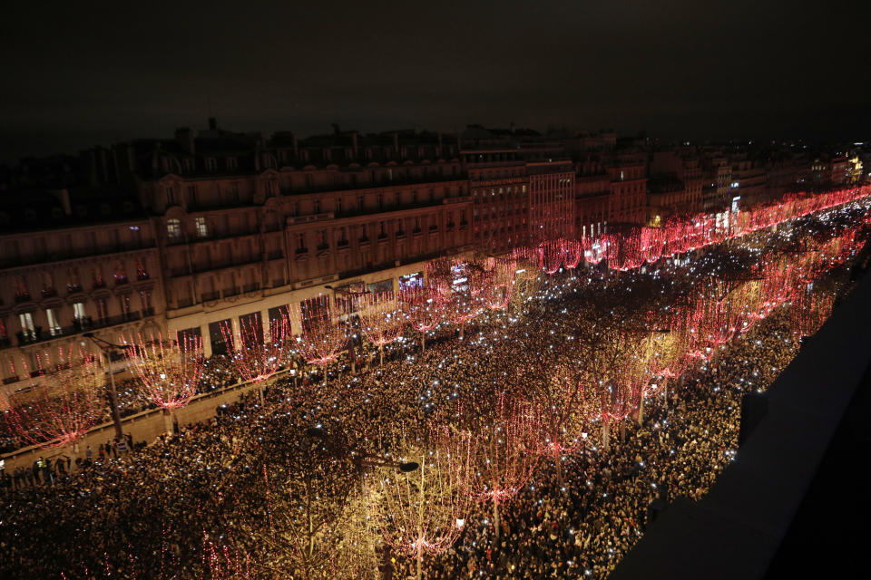 Spectators gather to attend the New Year's Day celebrations on the Champs-Elysees, in Paris