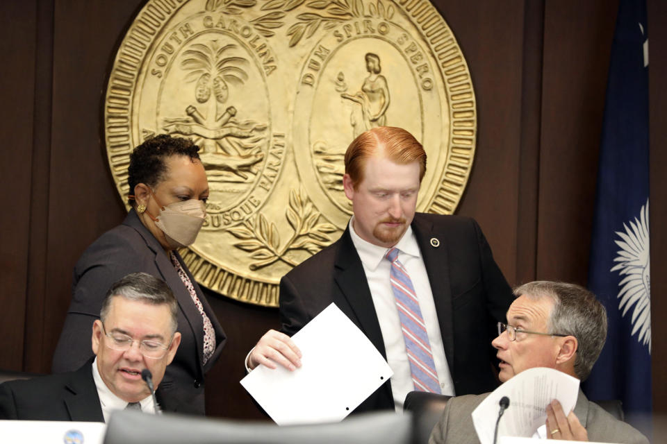 South Carolina Rep. Josiah Magnuson, R-Campobello, center, talks to other members about change to a bill being considered by a special House committee looking at a stricter abortion law in the state on Tuesday, July 19, 2022, in Columbia, S.C. (AP Photo/Jeffrey Collins)