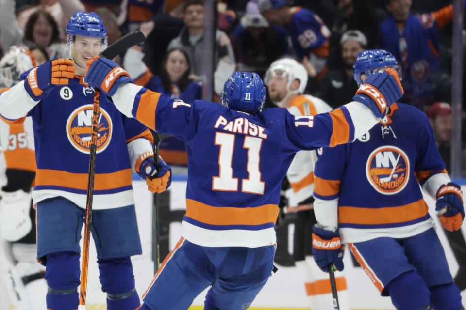 New York Islanders left wing Zach Parise (11) celebrates his goal with defenseman Scott Mayfield, left, during the third period of an NHL hockey game against the Philadelphia Flyers, Tuesday, Jan. 25, 2022, in Elmont, N.Y. (AP Photo/Corey Sipkin).