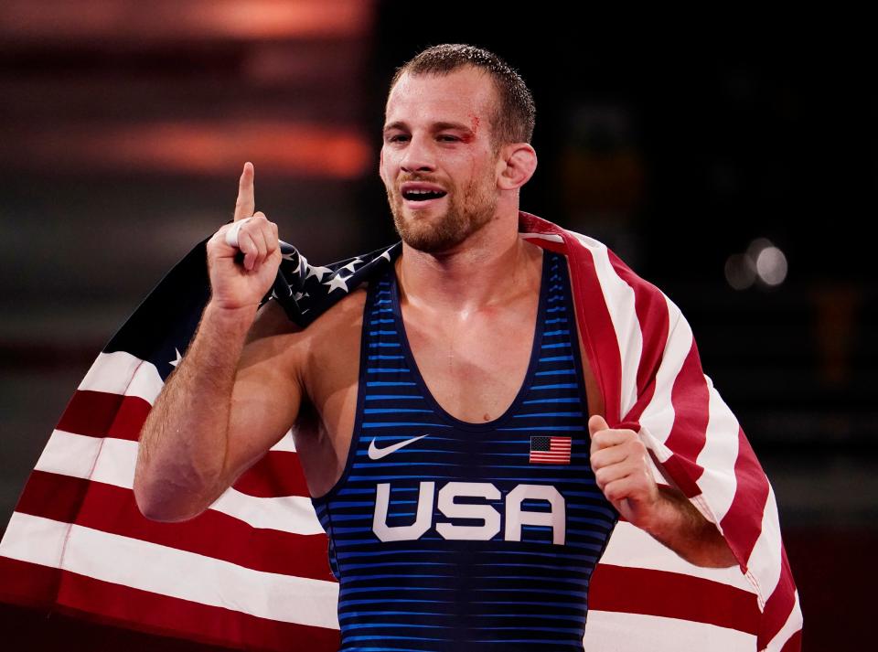 David Taylor wins gold and celebrates after defeating Hassan Yazdanicharati in the men's freestyle 86kg final.