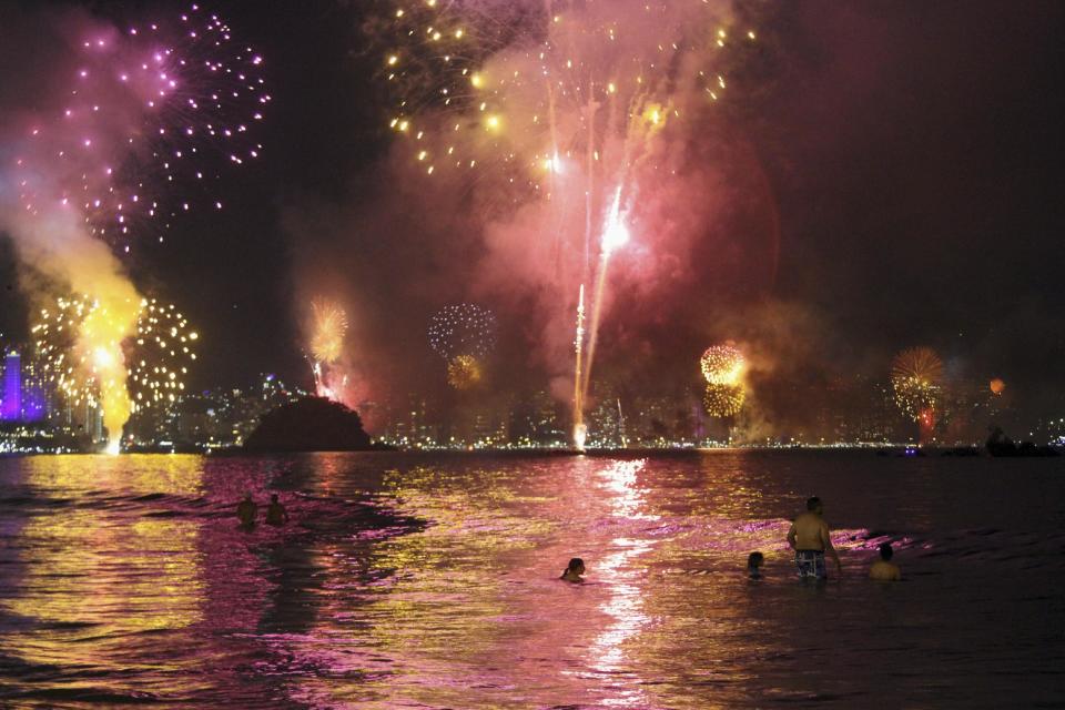 Fireworks explode over the Acapulco bay during a New Year's Eve celebration in Acapulco, Mexico, Sunday, Jan. 1, 2017. At least five people were killed over the New Year's weekend in the Mexican resort city of Acapulco, including three men found decapitated in a central neighborhood.(AP Photo/Bernandino Hernandez)