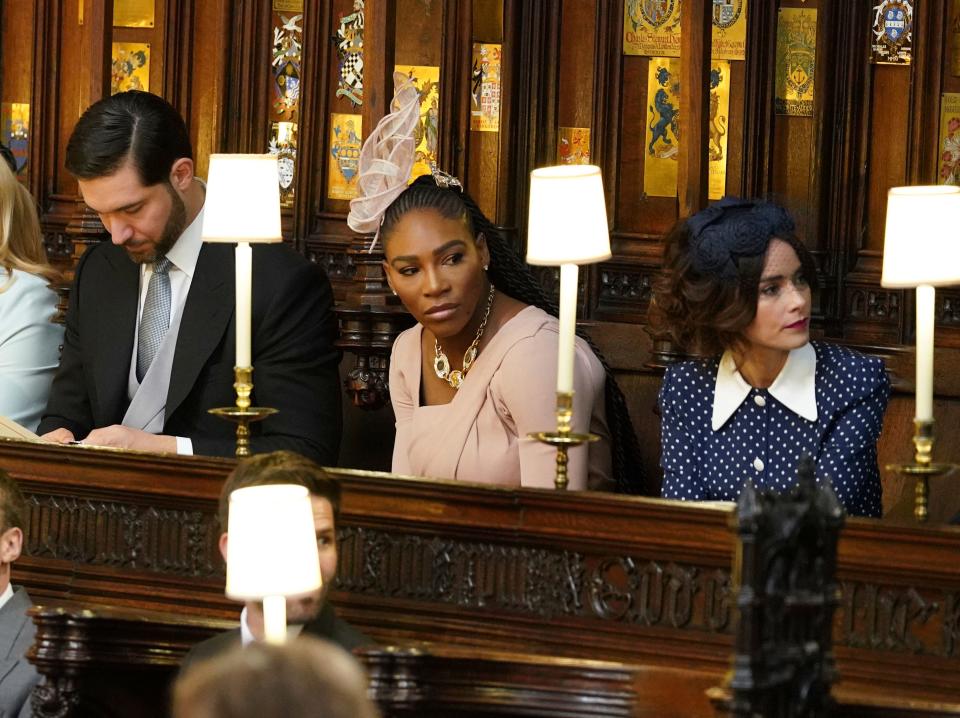 Alexis Ohanian (l) and his wife, Serena Williams, seated prior to the start of the wedding ceremony of Prince Harry and Meghan Markle at St. George's Chapel at Windsor Castle, May 19, 2018.