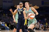 New York Liberty's Sabrina Ionescu drives to the basket past Dallas Wings' Allisha Gray (15) during the second half of a WNBA basketball game in Arlington, Texas, Wednesday, Aug. 10, 2022. (AP Photo/Tony Gutierrez)