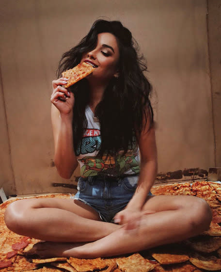 Pretty Little Liars actress Shay Mitchell declared devouring pizza “My Happy Place,” while wearing a Teenage Mutant Ninja Turtles T-shirt — appropriate since the turtles are also noted pizza fans. (Photo: Instagram)