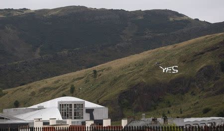 A 'Yes' sign is seen on Arthur's Seat above the Scottish Parliament in Edinburgh, Scotland, September 17, 2014. REUTERS/Russell Cheyne