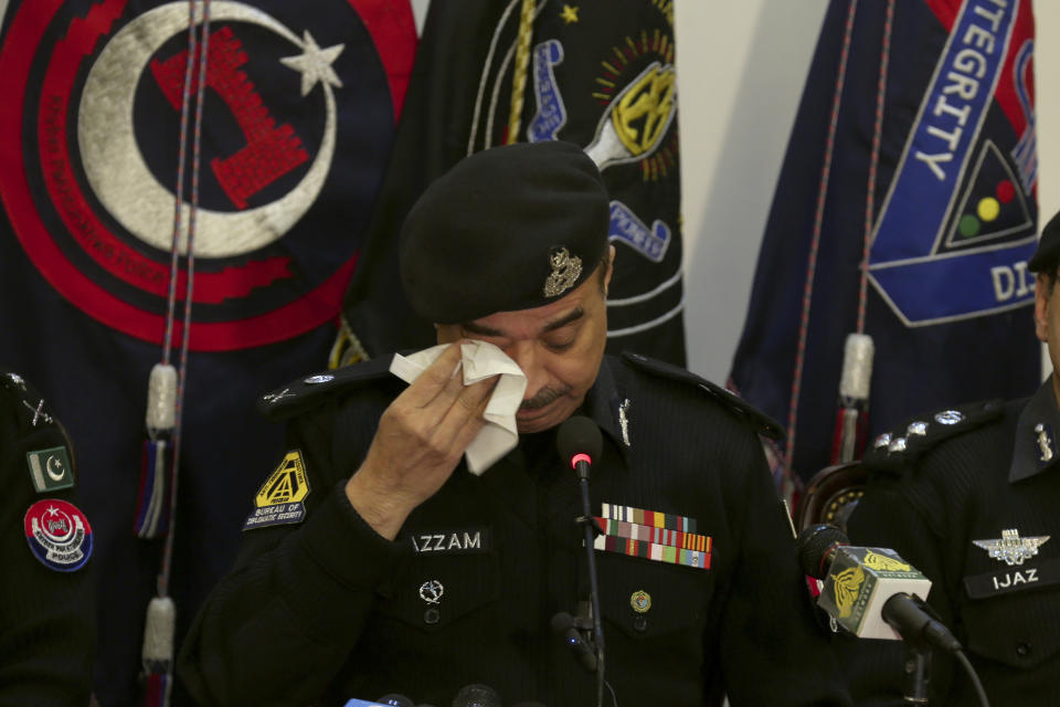Pakistan's Khyber Pakhtunkhwa provincial police chief Moazzam Jan Ansari wipes his eye during a press conference regarding the investigation of Monday's suicide bombing in Peshawar, Pakistan, Feb. 2, 2023. A suicide bomber who killed 101 people at a mosque in northwest Pakistan this week had disguised himself in a police uniform and did not raise suspicion among guards, the provincial police chief said on Thursday. (AP Photo/Muhammad Sajjad)